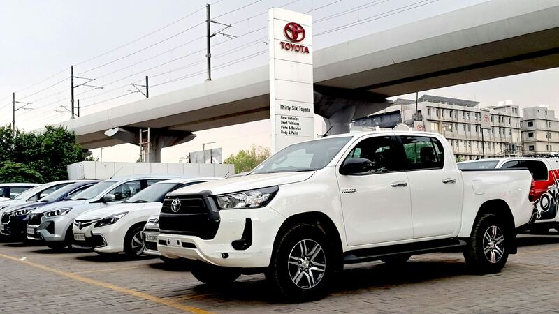 White pickups parked in a row (example photo)
